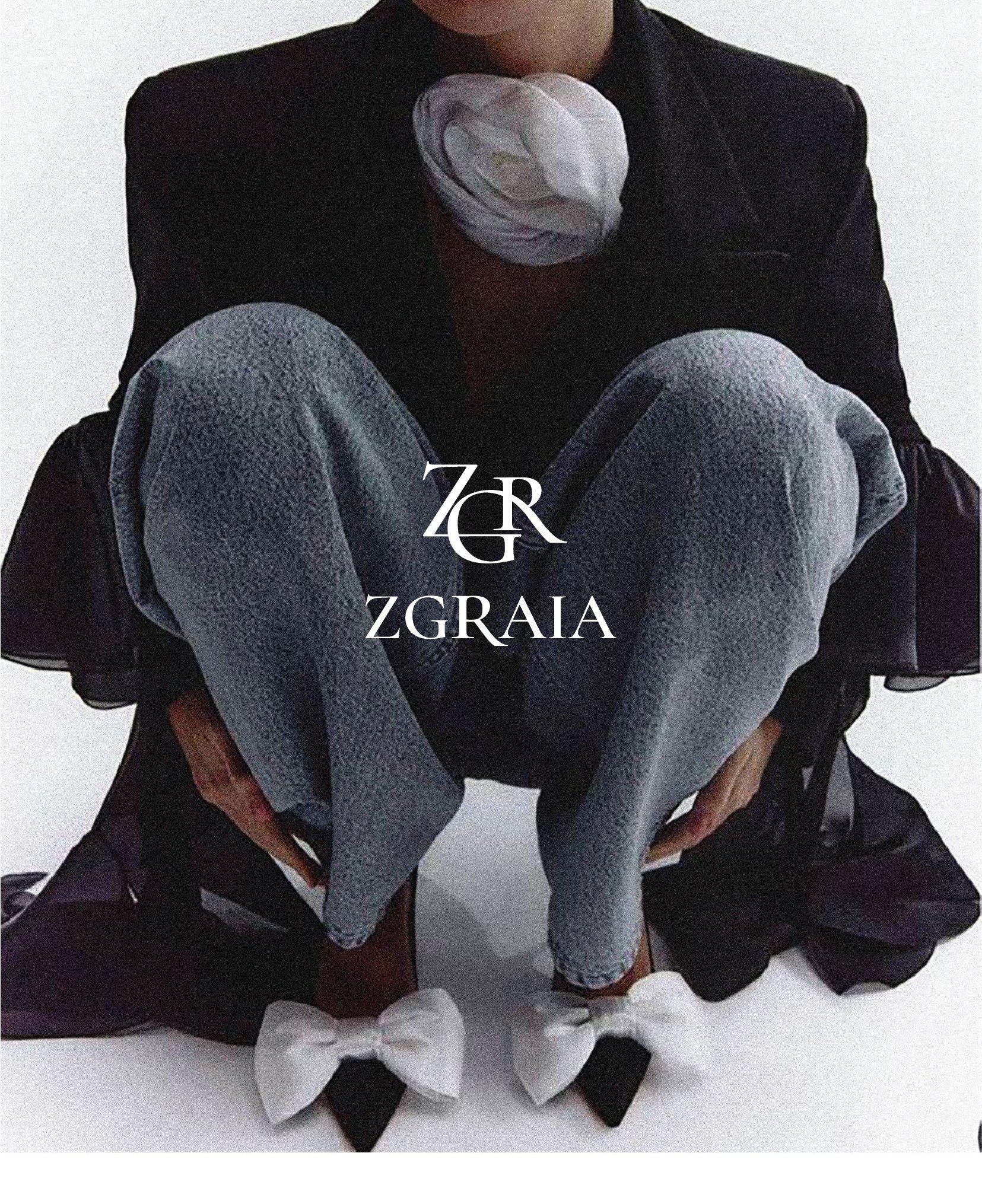 ZGRAIA — model in a tailored blazer and denim, wearing the ZGR monogram